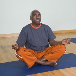 Senior doing a yoga pose on a yoga mat
